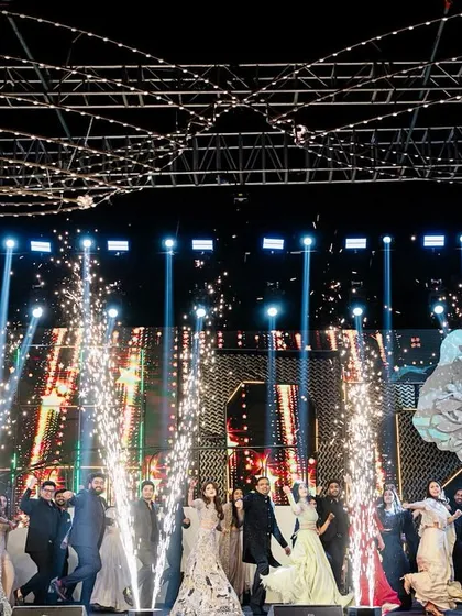 This is how we end a sangeet night, with a grand finale that brings everyone together. This shot captures the explosive energy of a full-family performance, complete with perfectly timed pyrotechnics that light up the stage and create a memory for a lifetime.