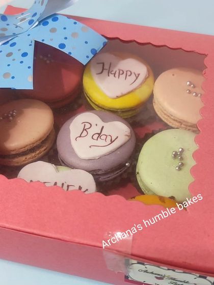 A personalized birthday macaron box, all packed up and ready to be gifted. The window on the box gives a beautiful sneak peek of the colorful and custom treats inside.