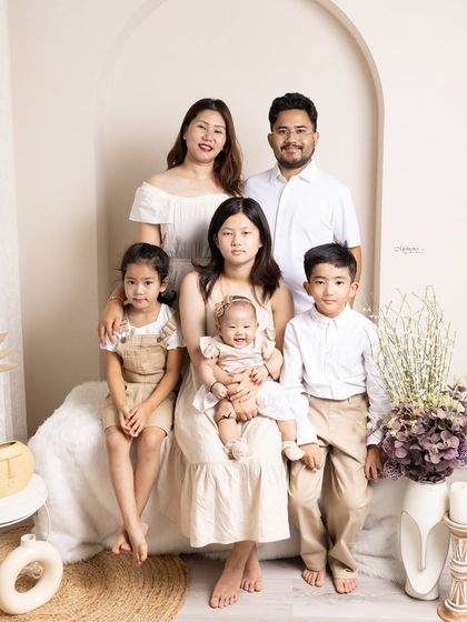 A moment of togetherness, captured forever. This beautiful family portrait, styled in neutral tones, is a timeless keepsake.