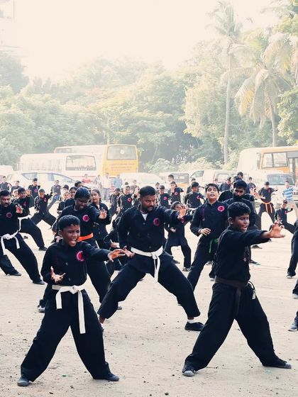 A dynamic shot of students in a horse stance, practicing punches. The focus on their faces shows the effort and concentration required.