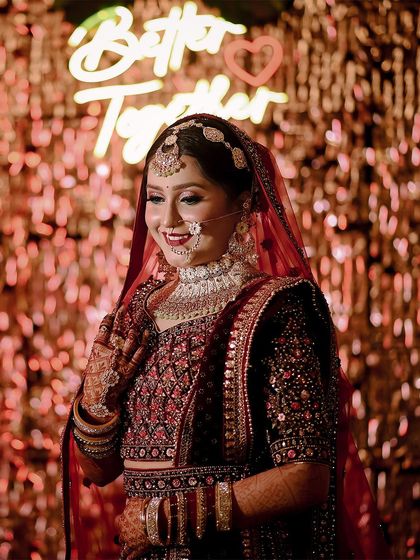A candid bridal portrait in front of a "Better Together" neon sign. The warm, festive background and her joyful smile perfectly capture the spirit of the celebration.