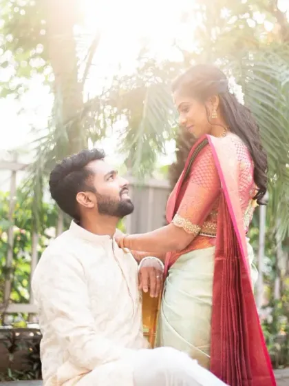 A romantic couple portrait in a beautiful garden setting. The natural light and greenery create a soft and dreamy atmosphere.
