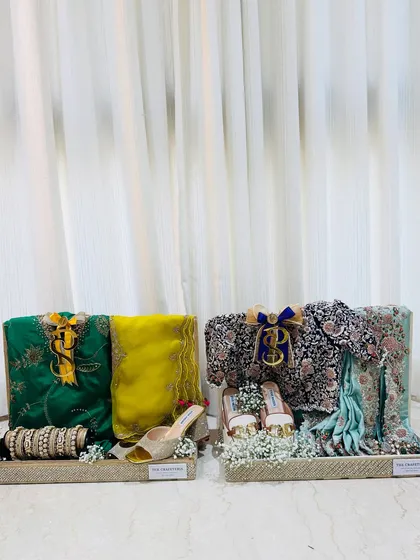 Two trousseau trays, side-by-side. Each one is a work of art, styled to reflect the bride's personality and the spirit of the occasion.