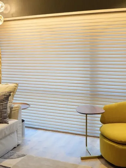 A cozy corner in the Lodha World One apartment, featuring a vibrant yellow armchair that adds a cheerful pop of color. The design shows how even small spaces can be infused with personality and style.