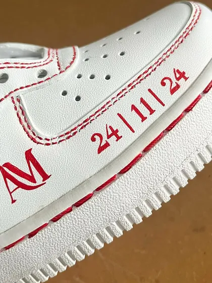 Personalizing these custom sneakers with an important date and initials.