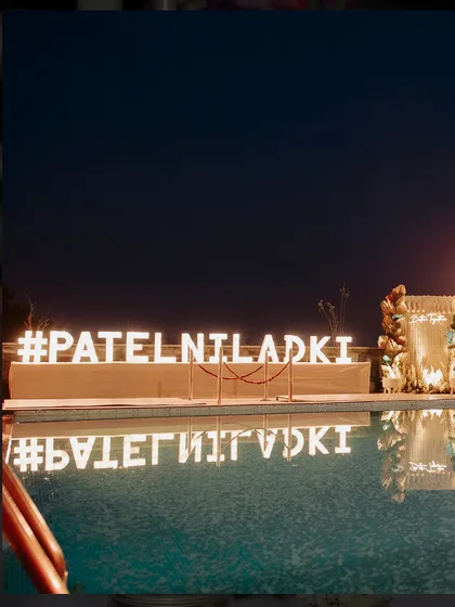 A personalized hashtag, #PATELNILADKI, was created in large, illuminated letters by the pool, providing a perfect photo opportunity and a unique touch to the celebration.