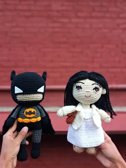 A fun custom order combining a personalized doll with a pop culture icon. I created a doll based on the client's photo alongside a handmade Batman figure.