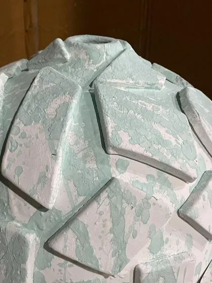A close-up detail of the pre-fired sculptural piece. You can see the layers and textures that will interact with the glaze in the kiln.