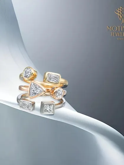A collection of our modern, stackable rings featuring various diamond shapes like trillion, emerald, and round cuts, perfect for creating a personalized look.