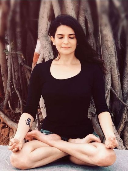 A moment of meditation in Padmasana (Lotus Pose) under a banyan tree. This is where I connect to my center, finding the stillness that I aim to share with all my students.