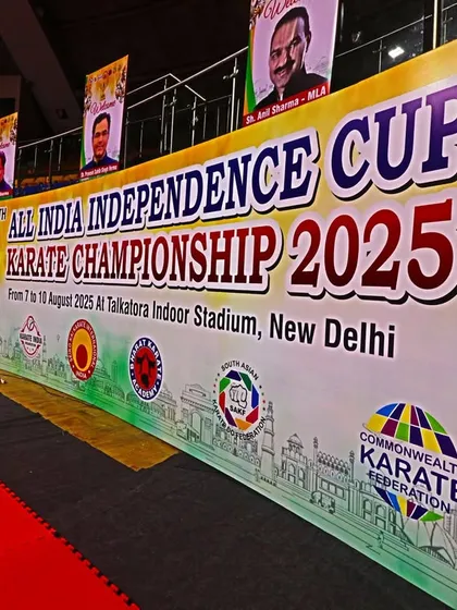 A close-up of the official banner for the 19th All India Independence Cup, displaying the logos of our affiliate federations like WKF, AKF, and the Commonwealth Karate Federation.