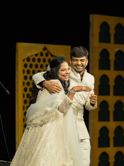 The brother of the bride shares a dance with his sister. For the sangeet, we styled him in a custom ivory sherwani that was both regal and comfortable for a night of performances.