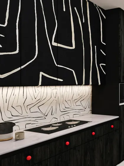 The kitchen cabinets and backsplash feature a continuous abstract line-art pattern, turning a functional space into a piece of art. Red knobs add a playful pop of color.