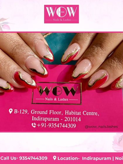 A fiery and artistic design. This look features a nude base with abstract swirls of red and metallic gold, creating a look that is both modern and luxurious.