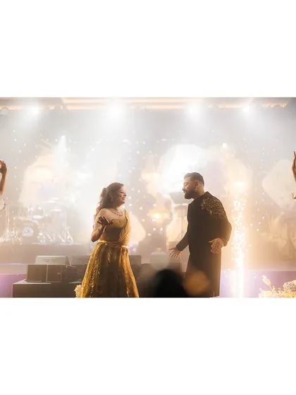 A candid shot of the couple's Sangeet performance, with sparklers adding a touch of magic to their dance.