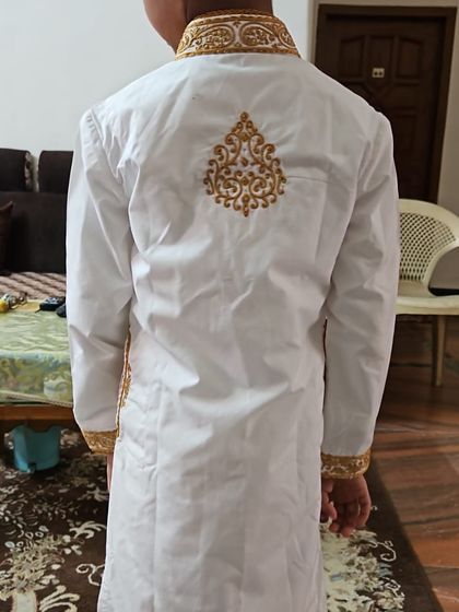 A back view of the custom saya kurta I made for a customer's son. This photo was part of the wonderful feedback I received, showing the detailed embroidery and the perfect fit of the garment.