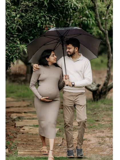 A simple walk under an umbrella becomes a romantic and cherished memory. This candid shot of an expecting couple in a lush garden setting shows how I find beauty in everyday, unposed moments.