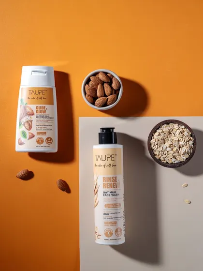 A minimalist composition featuring two Taupe products with their core ingredients. The clean lines, color blocking, and careful placement make this image feel fresh, modern, and perfect for a contemporary skincare brand.