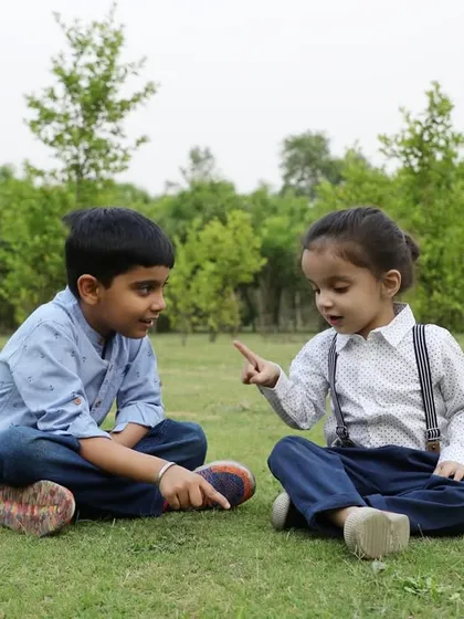 Two brothers sharing a conversation while sitting on the grass. These are the quiet, candid moments that truly tell the story of your family's relationships.