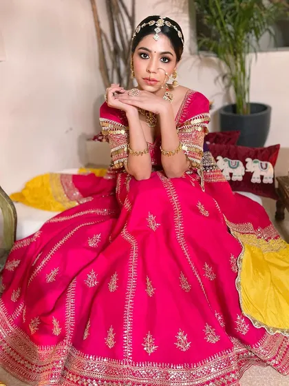Posing with grace and confidence. This full-length view showcases how the complete look, from the matha patti to the soft makeup, comes together for a picture-perfect bridal moment.