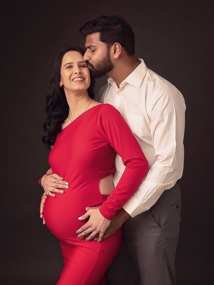 A tender kiss on the forehead, a gesture of love and care. This is a beautiful, intimate moment captured forever.