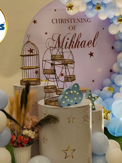 A serene and beautiful Christening setup for Mikhael. The decor features a "Twinkle Twinkle Little Star" theme with a blue and white color palette, a crescent moon backdrop, and star accents.