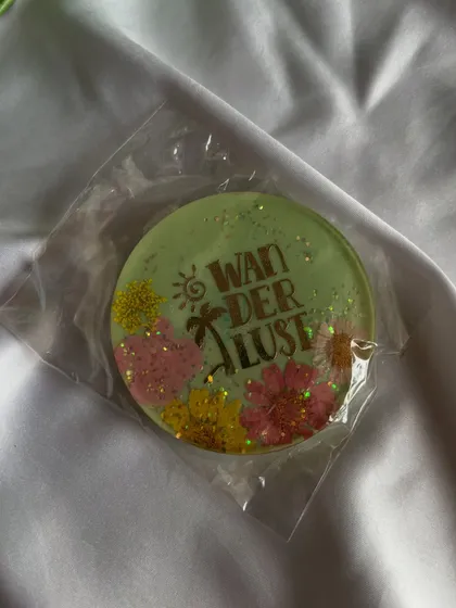 "Wanderlust." A cute, travel-themed magnet for your collection, part of the final sale.