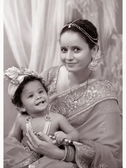 A black and white version of the mother and child Janmashtami portrait. This classic edit highlights their expressions and the intricate details of their attire.