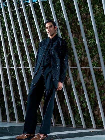 A full-length view of a black, subtly embellished Indo-Western outfit. The relaxed yet structured silhouette offers a sophisticated and comfortable option for evening festivities.
