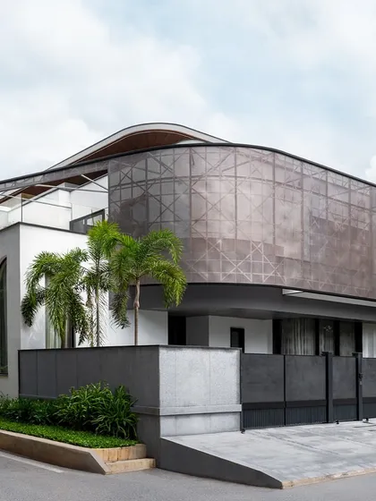 For the Juneja Residence, we designed a unique perforated metal screen that wraps around the upper floor. This architectural element provides privacy and shade from the western sun while creating a dynamic, modern facade that makes a bold statement.