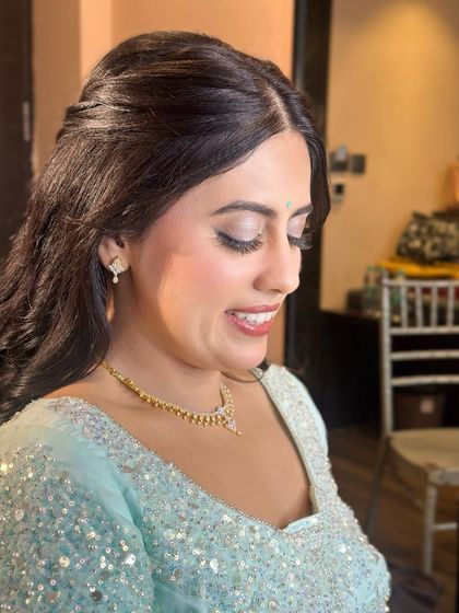 A side profile showing the soft curls and the glowing highlight on her cheekbones.