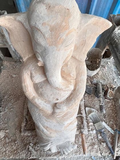 A different view of an unfinished Ganesha sculpture. At this stage, I focus on the overall balance and form, ensuring the proportions are right before moving on to the detailed work of the trunk, hands, and clothing.