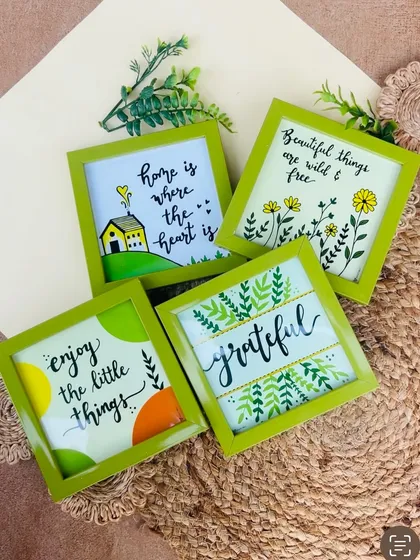 Our 'Green Quoted Combo' is perfect for adding a touch of nature and positivity to your home. This image shows the four green glass frames included in the set, each with a unique hand-doodled design.