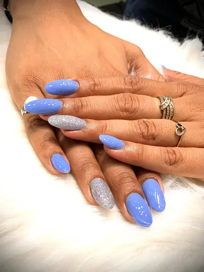 A chic and simple glam look with periwinkle blue nails and silver glitter accent nails.