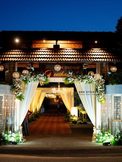 The perfect welcome to a magical Sangeet night. We designed this grand entrance with elegant white drapes, floral arches, and warm chandelier lighting, setting a luxurious and inviting tone for the celebration ahead.