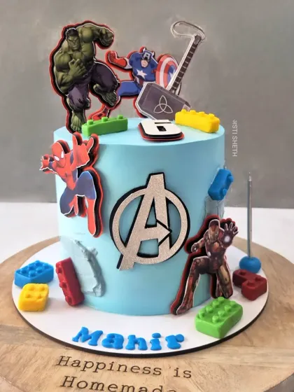 Avengers assemble! This superhero cake features Iron Man, Captain America, Hulk, and Spiderman, complete with the Avengers logo and colourful Lego blocks.