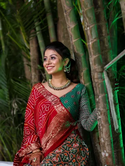 A stunning shot of the client in her traditional bandhani saree. The makeup is soft and glowing, complementing her natural beauty.