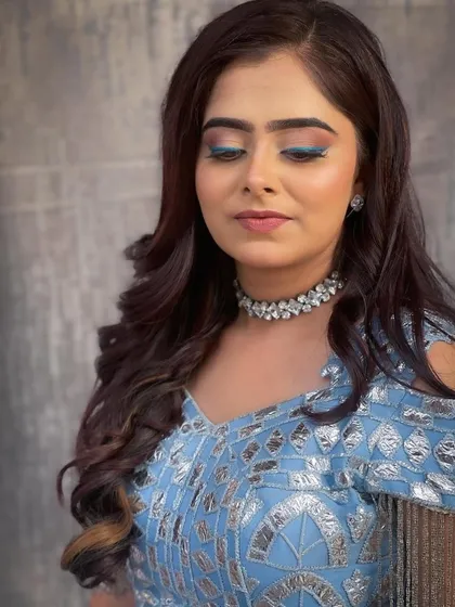 A close-up on the makeup and choker necklace, complementing the blue lehenga perfectly.