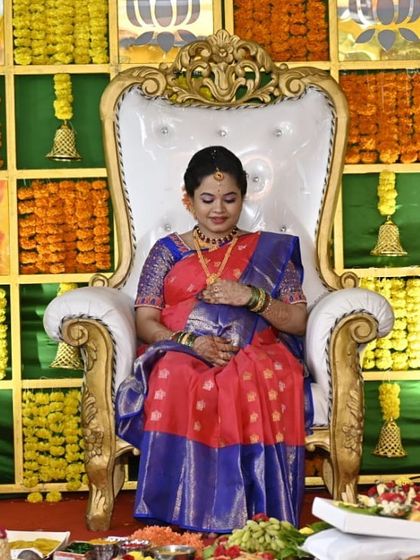 A serene moment during the baby shower ceremony. Her makeup is flawless, ensuring she looks her best for this cherished memory.