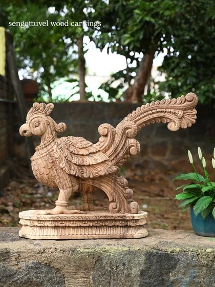 The wooden parrot statue, shown here with a plant to give a sense of scale and how it can be styled in a home.