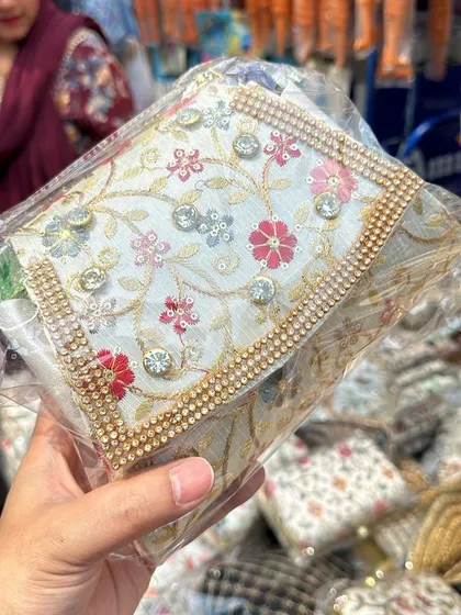 This embroidered clutch is embellished with rhinestones for extra sparkle. It's a glamorous piece that will definitely get you noticed.