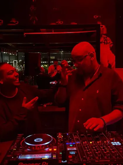 Chopping it up with another DJ mid-set. It's a community, and we're all here for the love of the music.