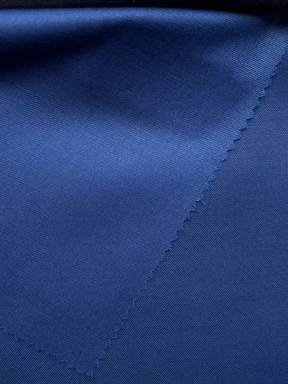 The deep, rich color of a blue wool suiting fabric, perfect for a powerful and elegant garment.