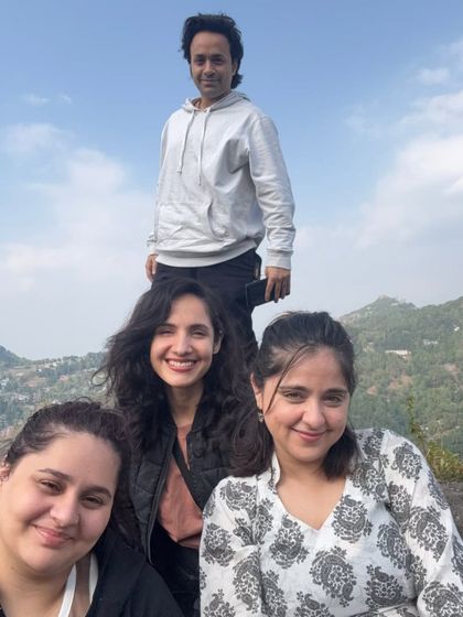 A happy group selfie on a mountain top. The smiles and shared joy after a trek are some of the most rewarding moments of any retreat.