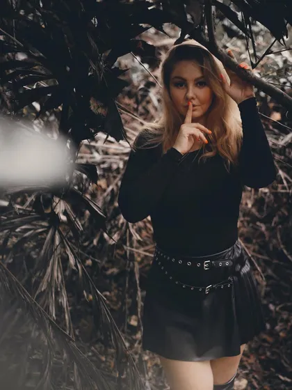 A dark and mysterious shot from a photoshoot in the jungle, playing with shadows and secrets.