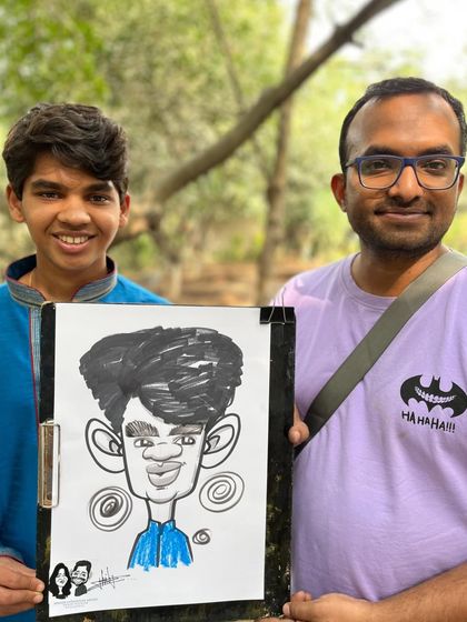 Posing with a young guest and his caricature at The Farm Ecoville. The outdoor setting provided a lovely, relaxed atmosphere for drawing.