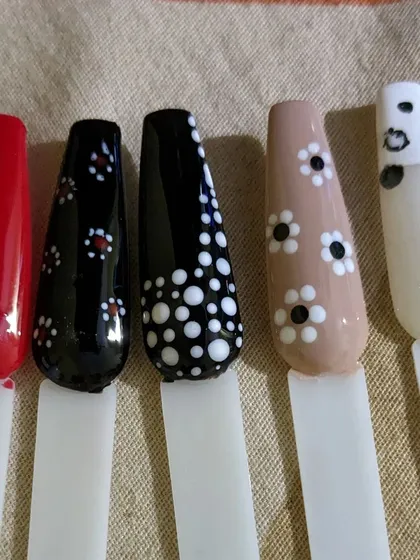 Dot patterns are a simple but very effective way to create unique nail art. Here are a few examples on different base colors like red, black, nude, and white.