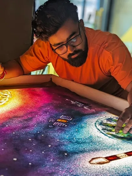 Creating the Aditya L1 mission sand art. Here I am adding details to the sun and earth.