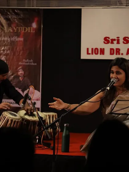 The artist interacting with the audience during the show. These moments of connection between the performer and the listeners are what make our live music events so special and engaging.