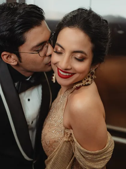 A close-up of Tessa's reception glam. We went for a classic bold red lip and shimmering golden eyes that caught the light beautifully. It’s a timeless look that feels both elegant and celebratory, perfect for dancing the night away.